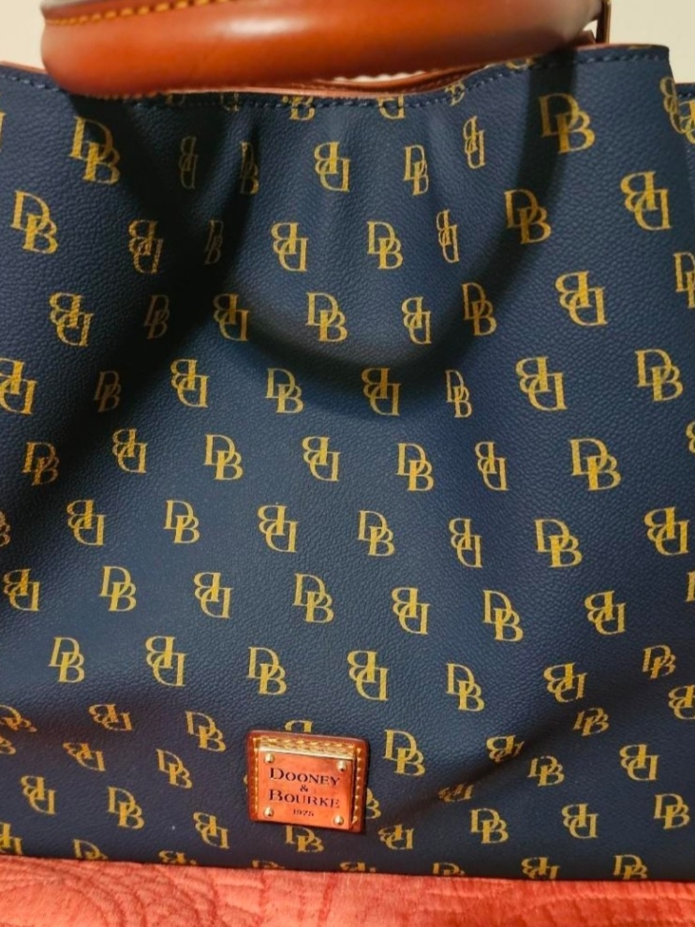 Pre-owned. Price Is Firm -Dooney & Bourke Navy and Gold Signature Tote.